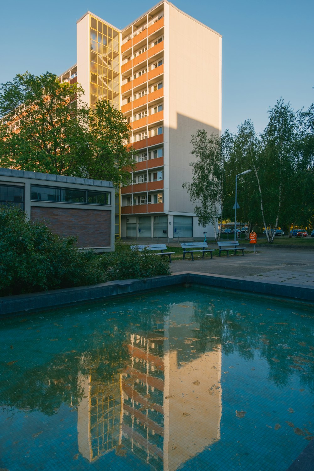 a reflection of a building in a pool of water