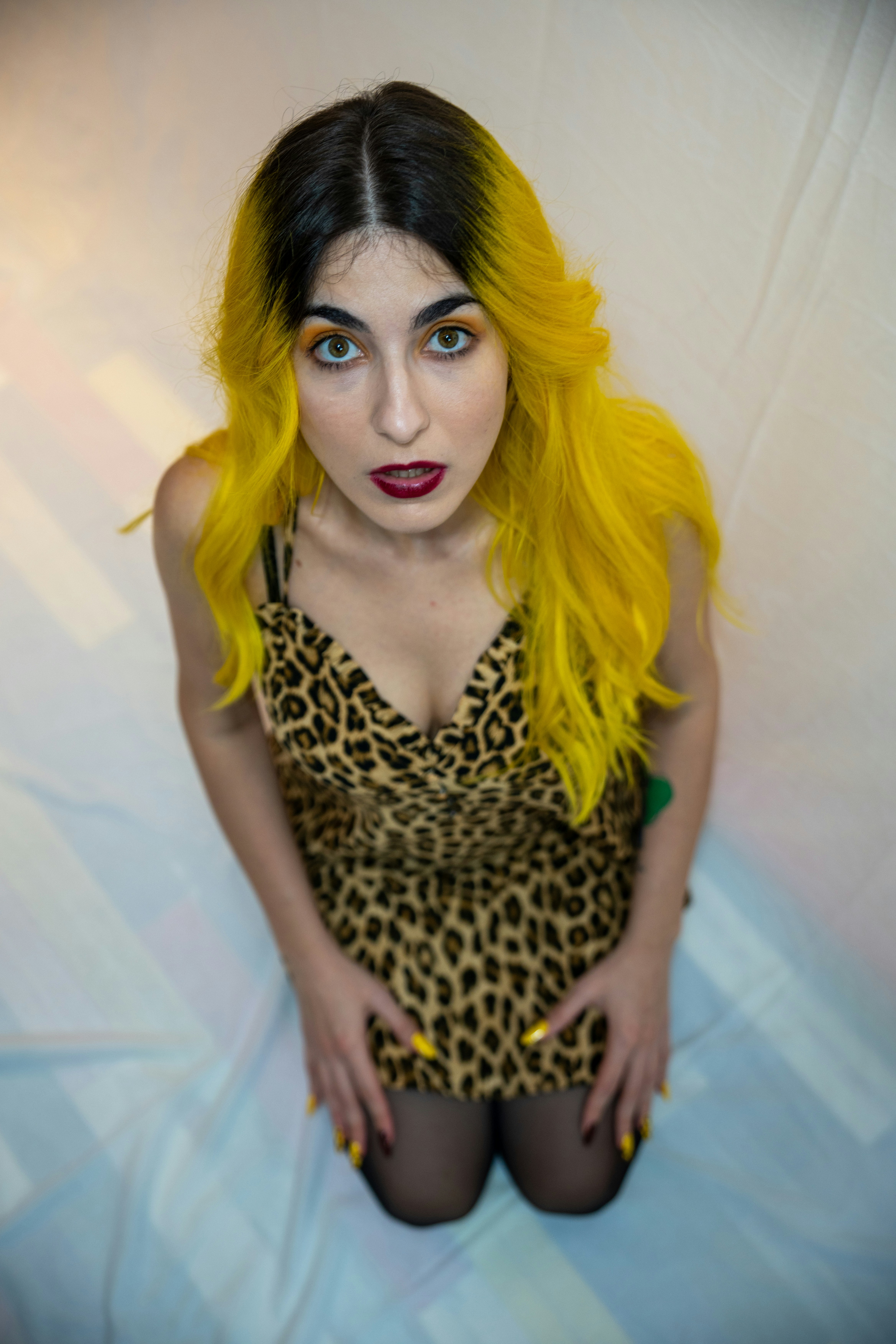 a woman with bright yellow hair and black stockings