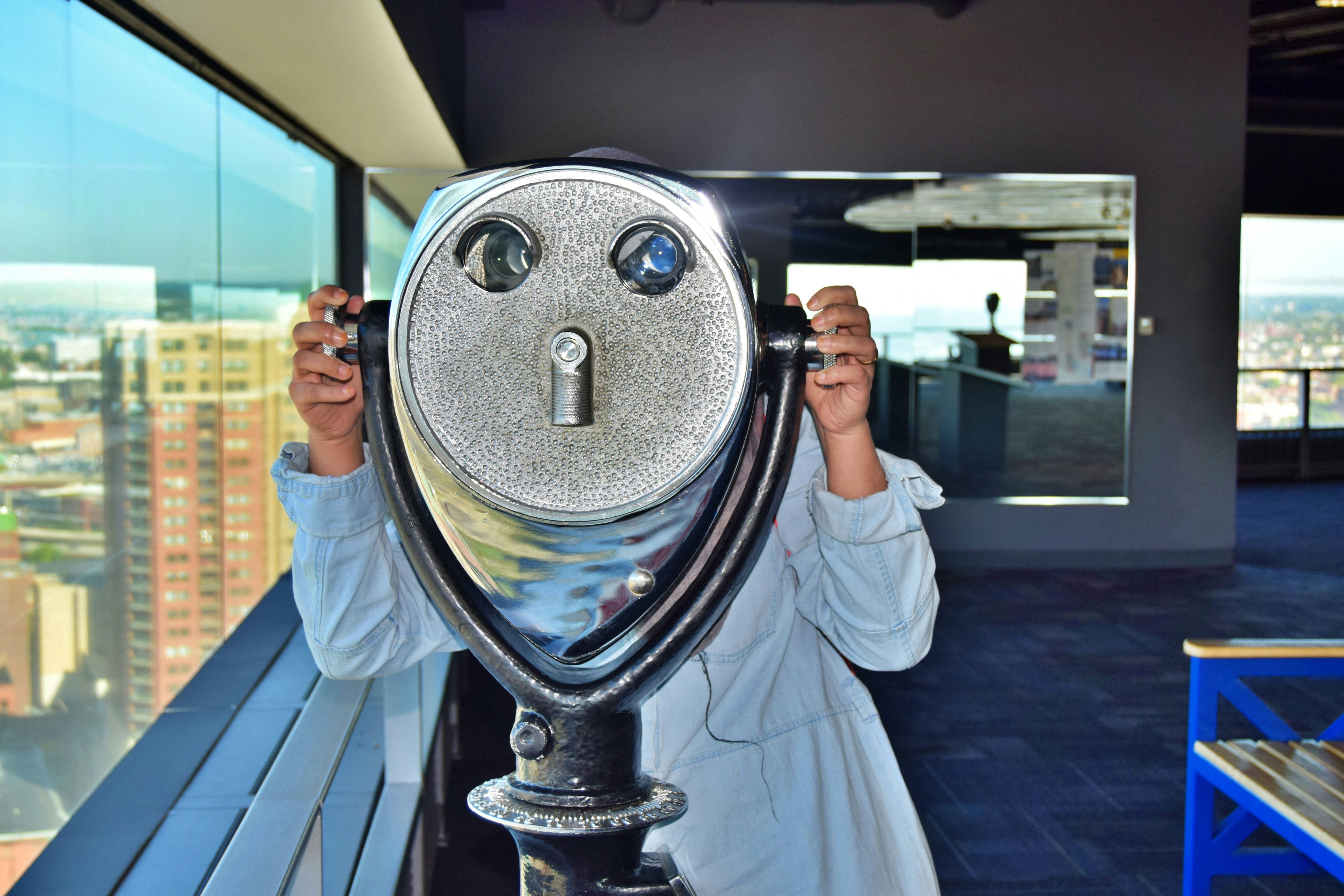 a woman looking through a hole in a telescope