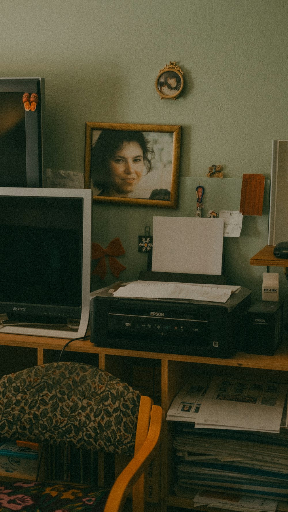 a living room with a desk and a television