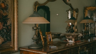 a dresser with a lamp on top of it
