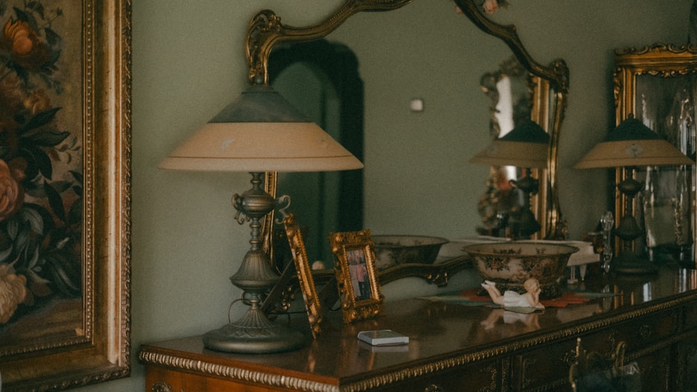 a dresser with a lamp on top of it