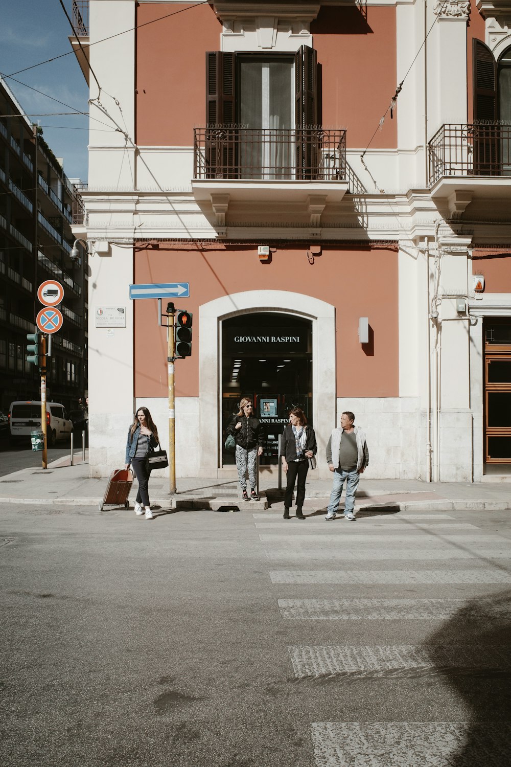 a group of people walking across a street