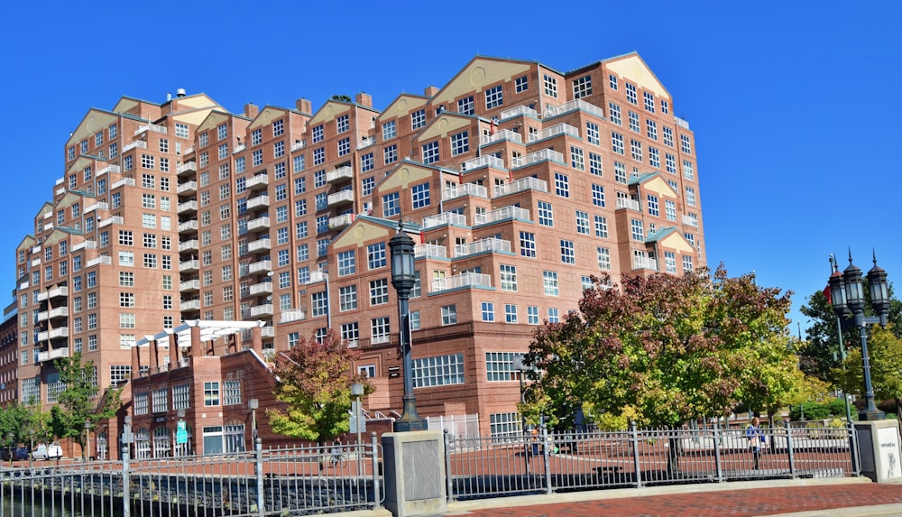 a tall brick building sitting next to a body of water