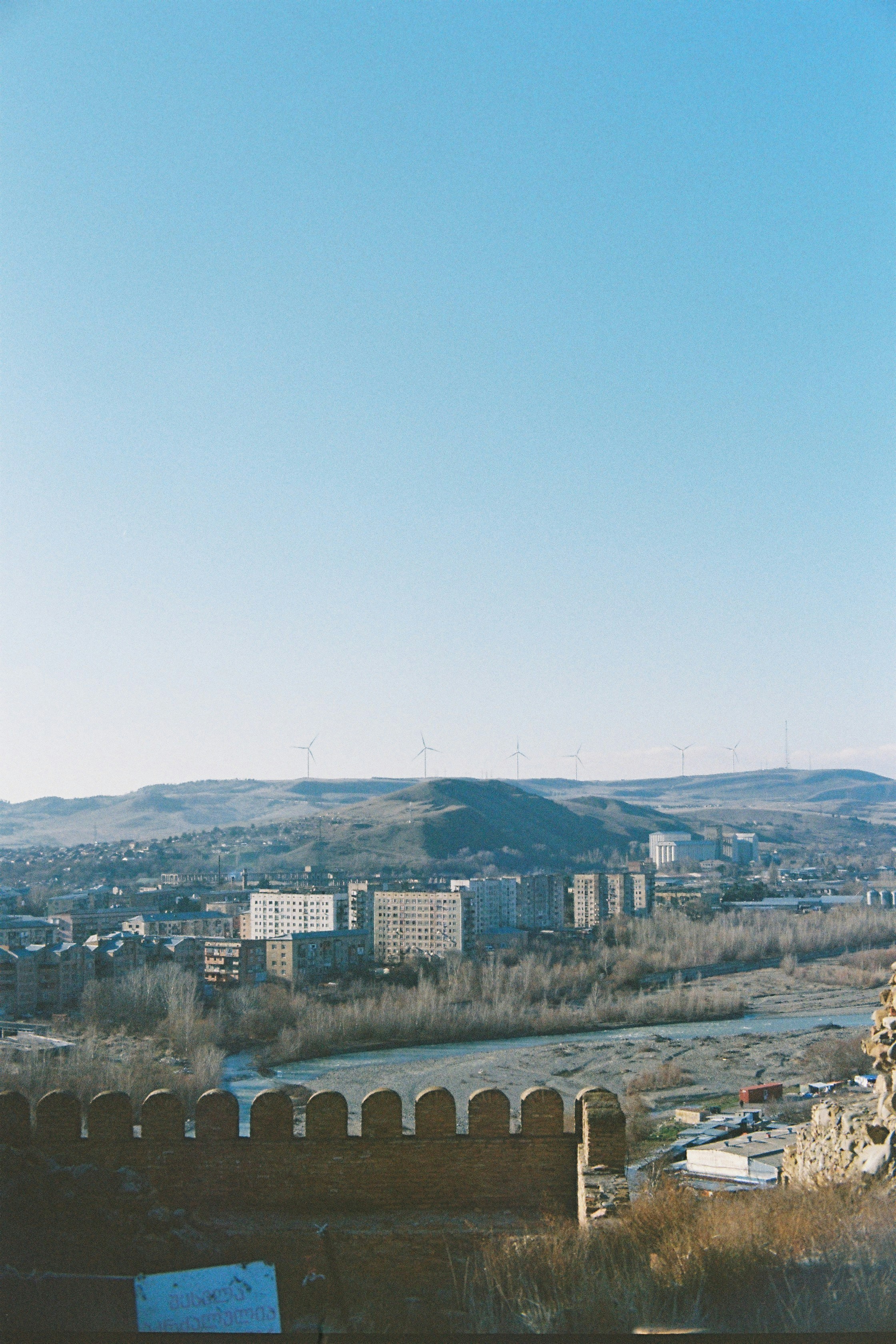 a view of a city and a river from a hill