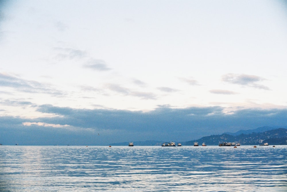 a group of boats floating on top of a large body of water