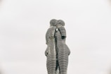a statue of two people standing next to each other