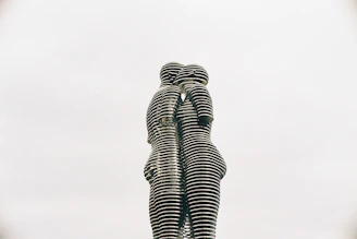 a statue of two people standing next to each other