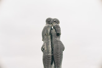 a statue of two people standing next to each other