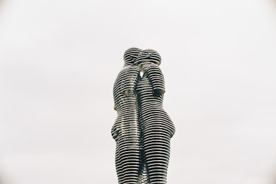 a statue of two people standing next to each other