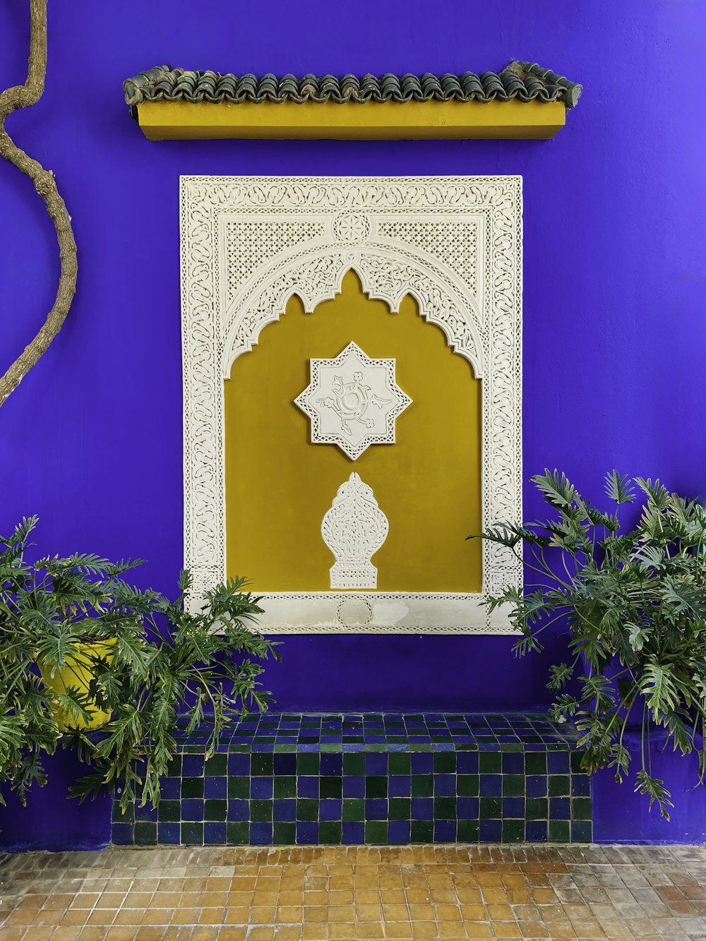 a blue wall with a yellow and white wall hanging over it