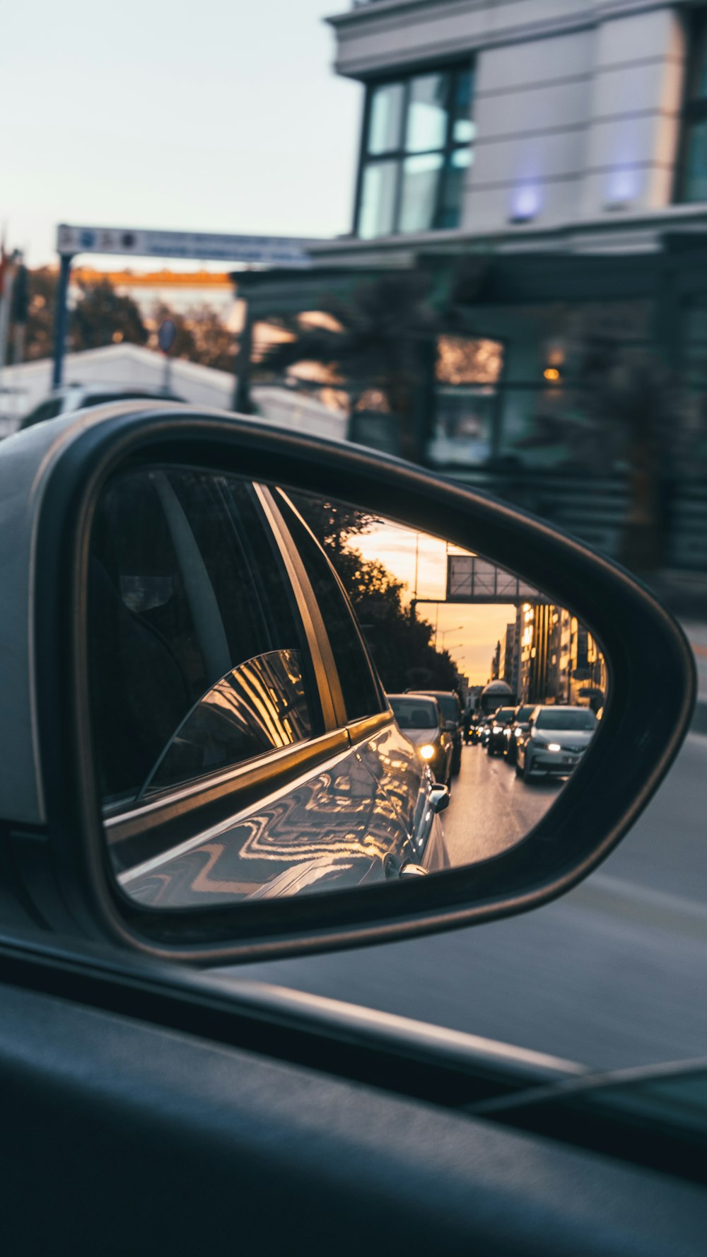 a rear view mirror on a car on a city street