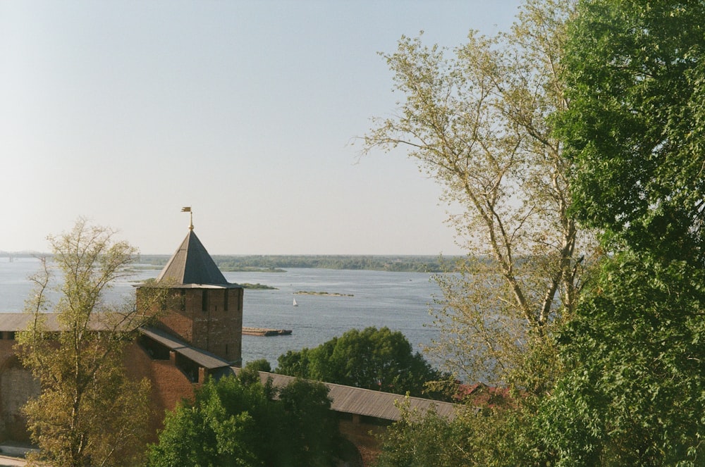 a church with a tower overlooking a body of water