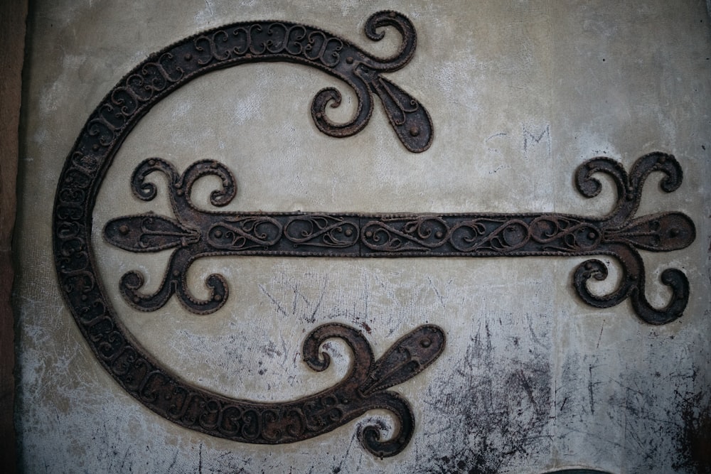 a decorative metal letter on a wall