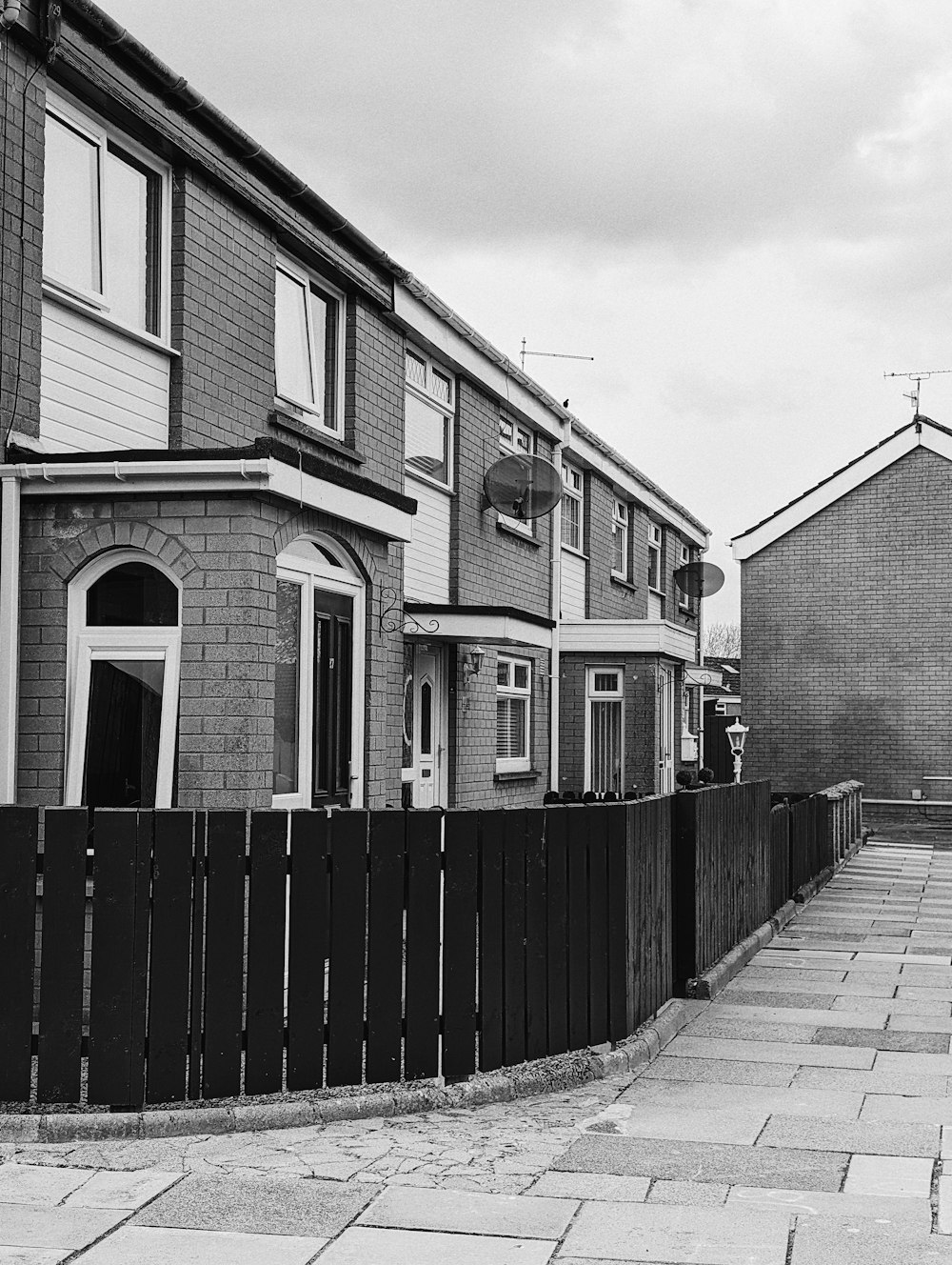 a black and white photo of a row of houses