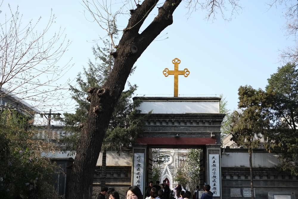 a group of people standing in front of a cross