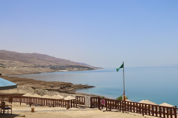A large body of water sitting next to a sandy beach — Dead Sea, Jordan
