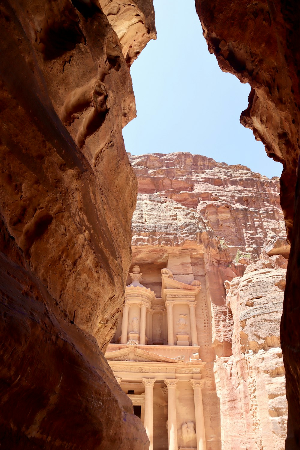 a view of a building through some rocks