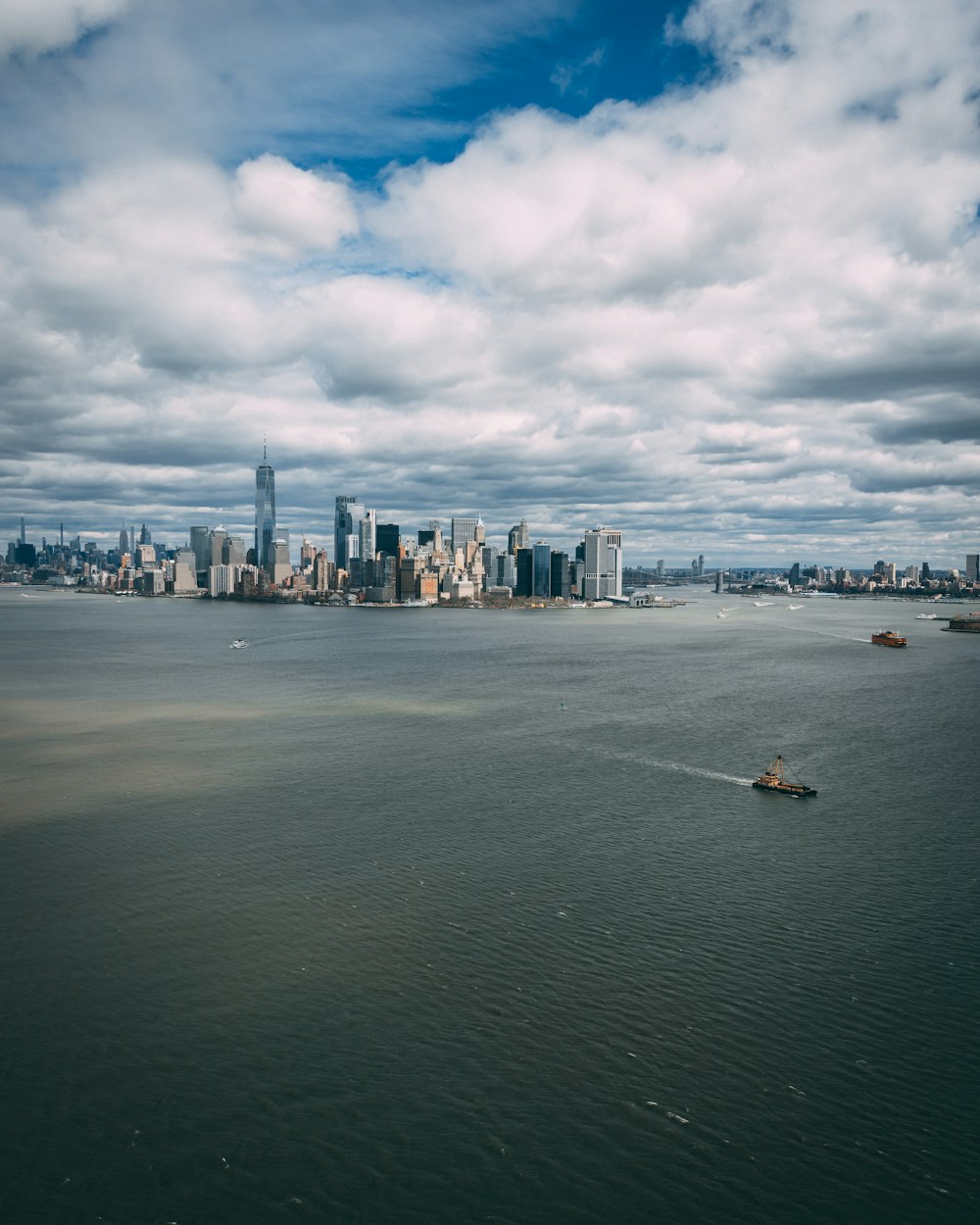 a large body of water with a city in the background