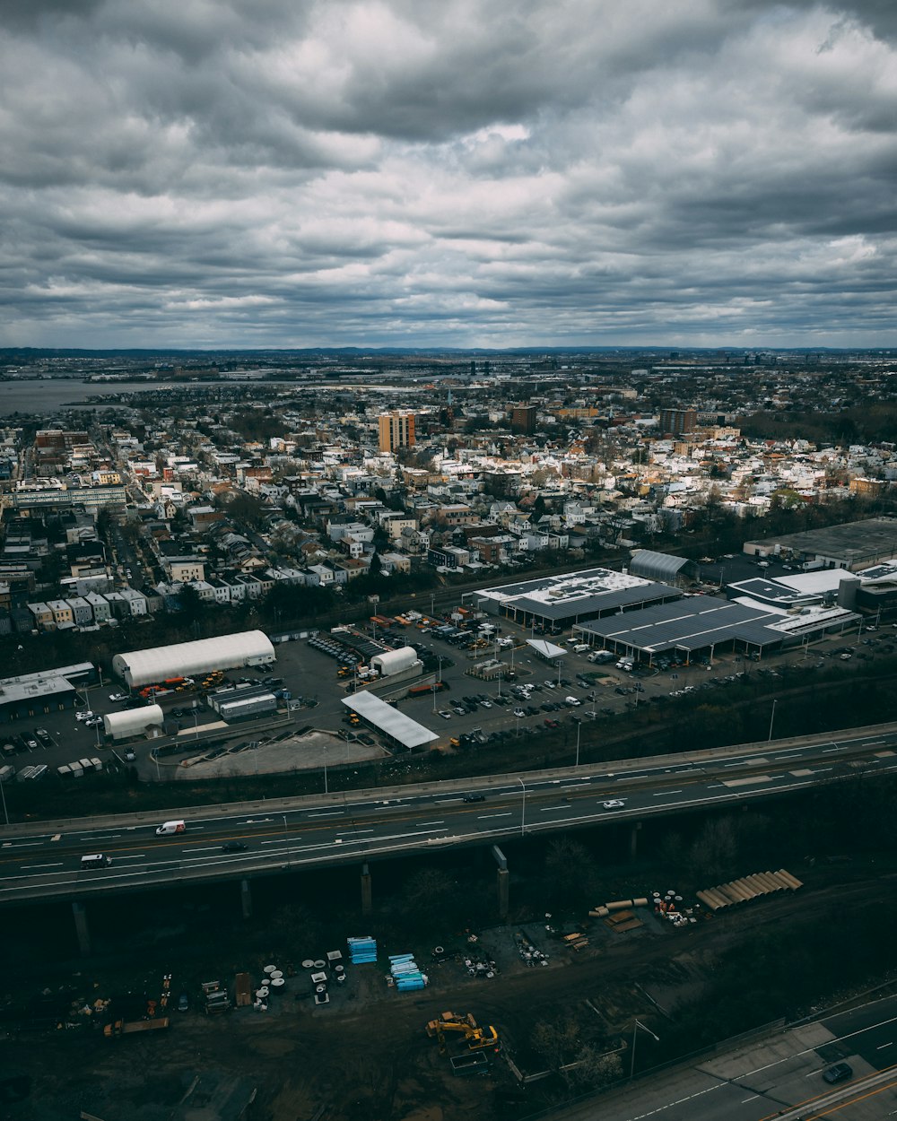 an aerial view of a city under a cloudy sky