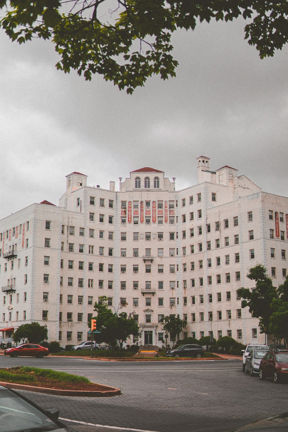 a large white building sitting on the side of a road