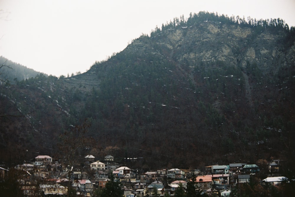 a mountain with houses on it and a hill in the background