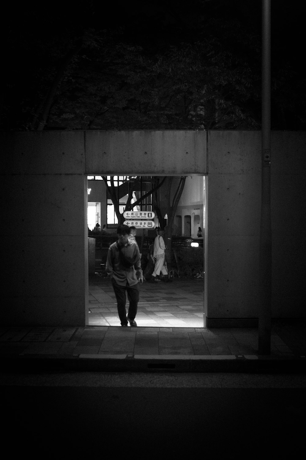 a man is walking out of a building