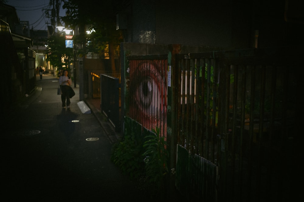 a person walking down a dark street at night