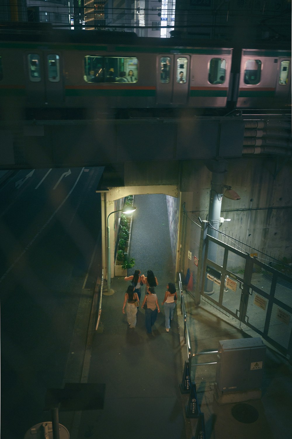 a group of people walking down a hallway next to a train