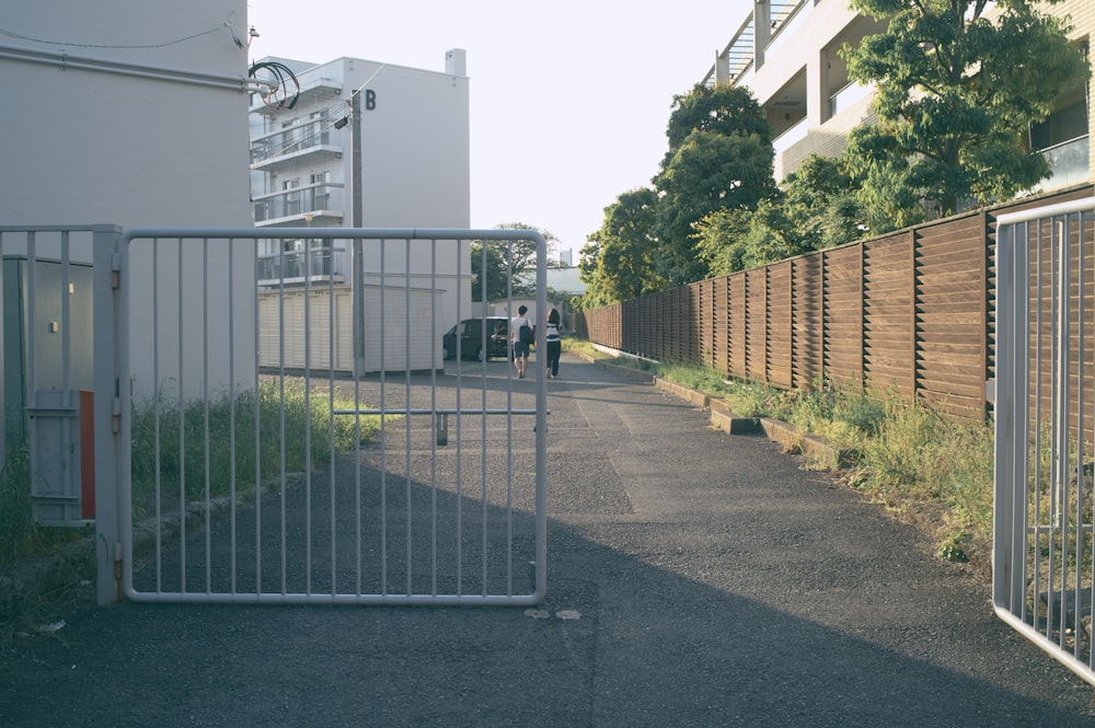 a white truck parked next to a tall fence