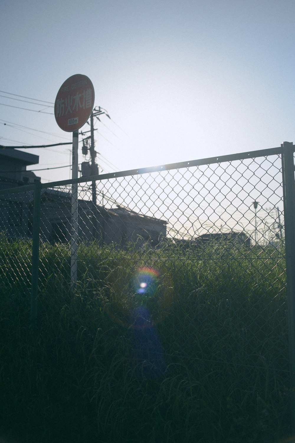 a fence that has a stop sign on top of it