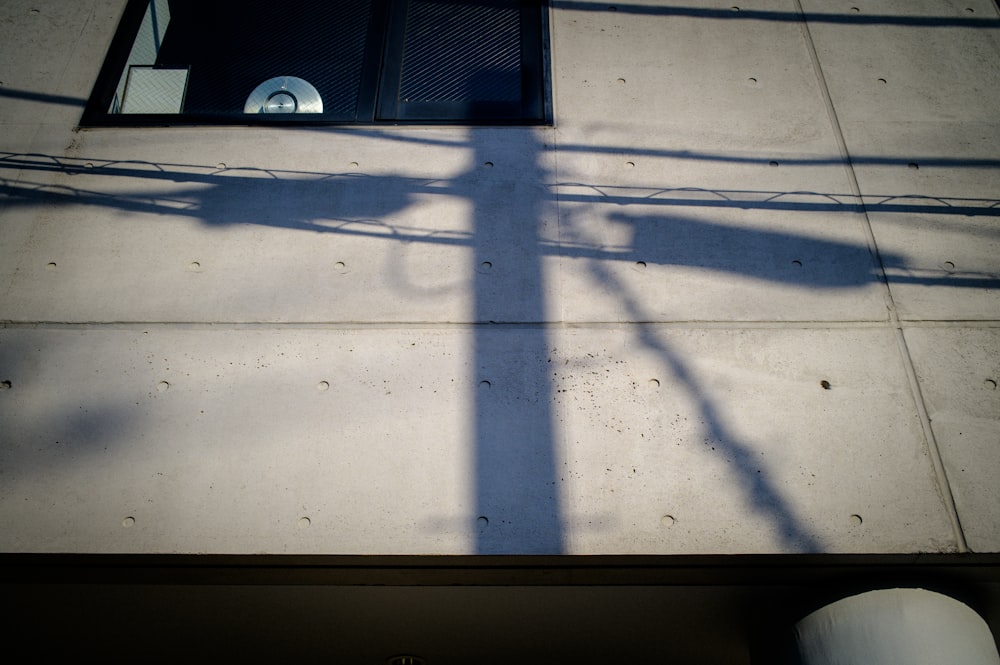 a shadow of a street light on a sidewalk