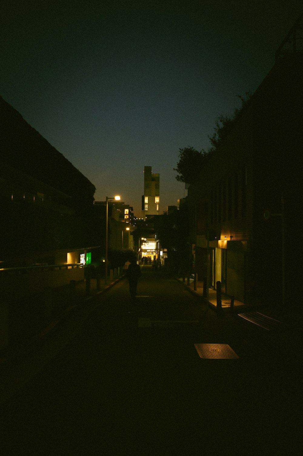 a person walking down a dark street at night