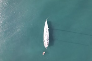 a white boat floating on top of a body of water
