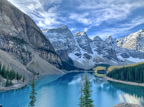a mountain lake surrounded by snow covered mountains