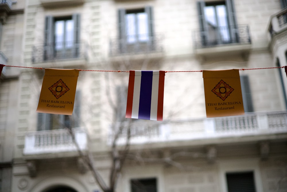 a couple of flags hanging from a clothes line