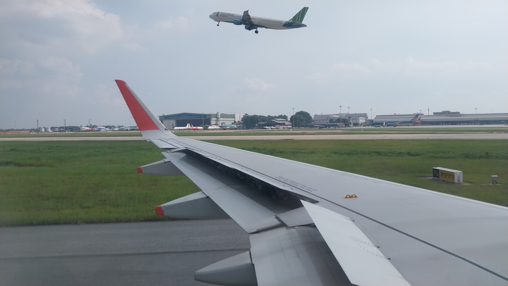 an airplane is flying over a grassy field