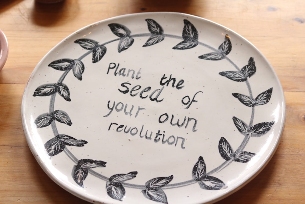 a plate with a quote on it sitting on a table