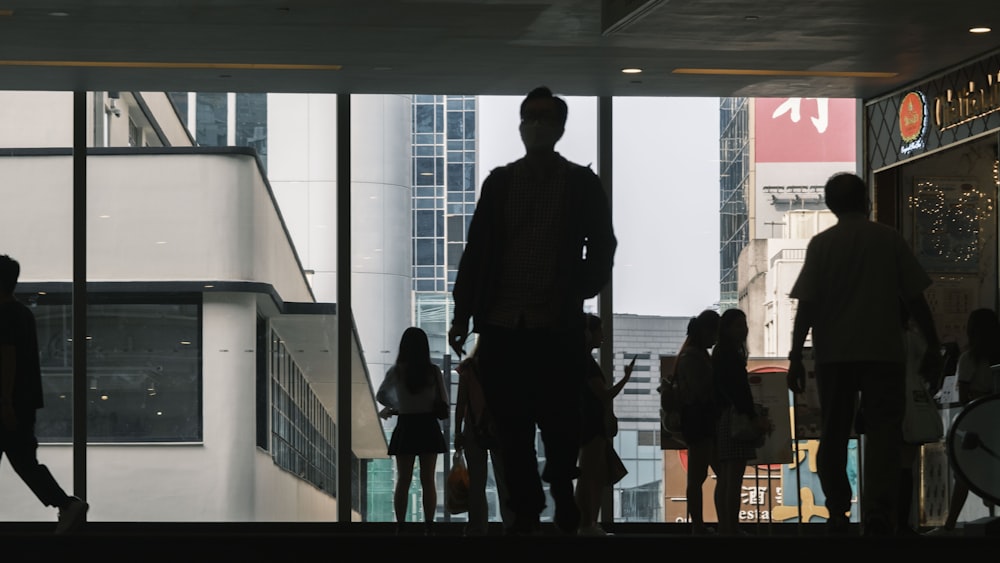 a group of people standing in front of a window