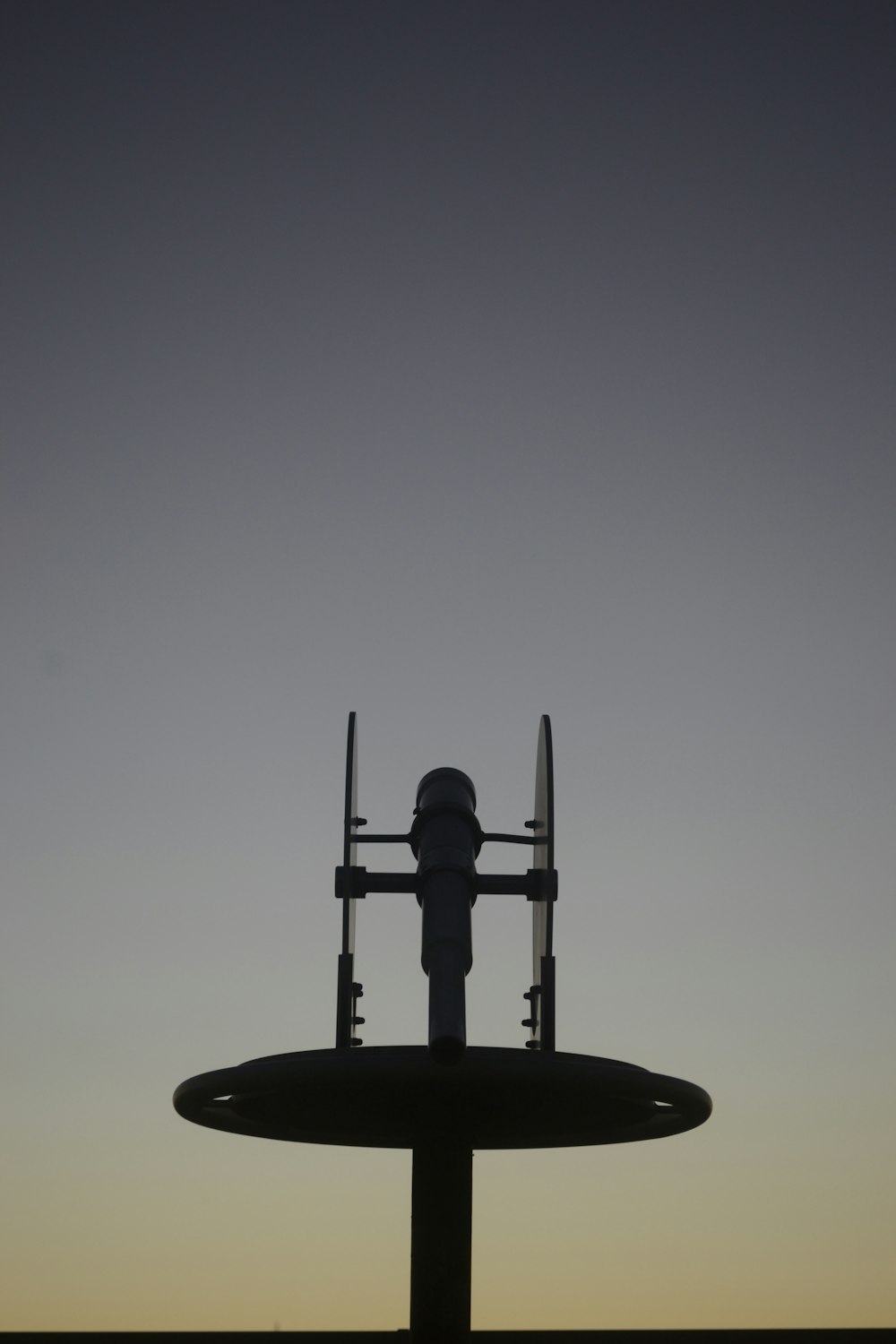 the silhouette of a man standing on top of a large object