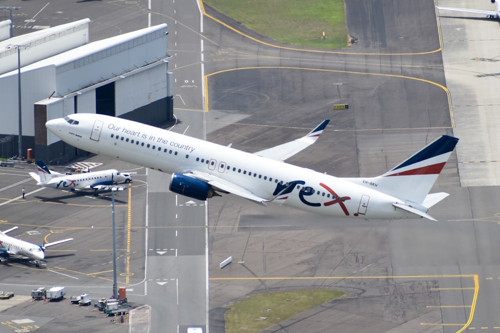 a large passenger jet flying over a runway