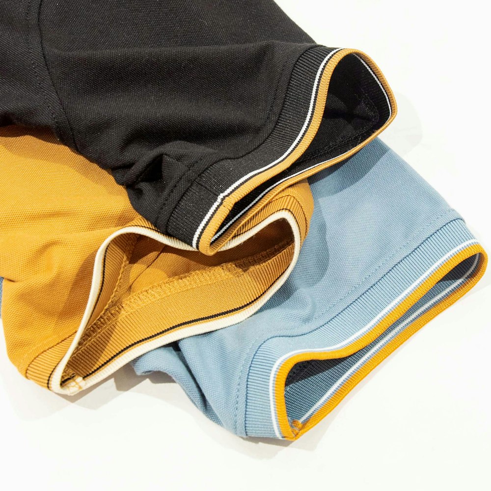 a close up of three different colored pants