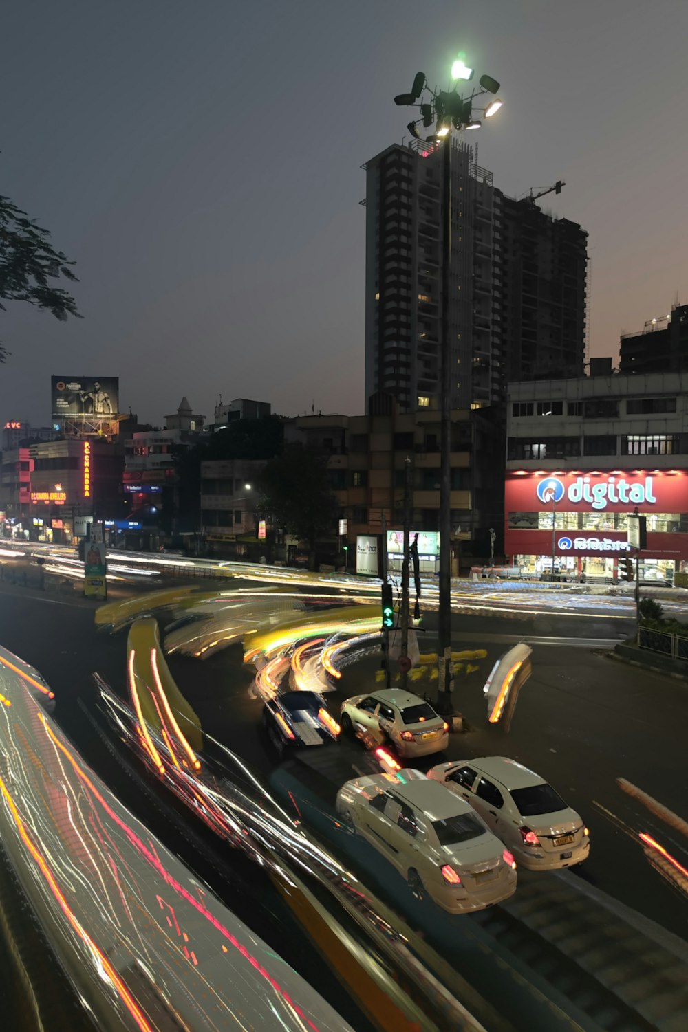 a city street filled with lots of traffic at night