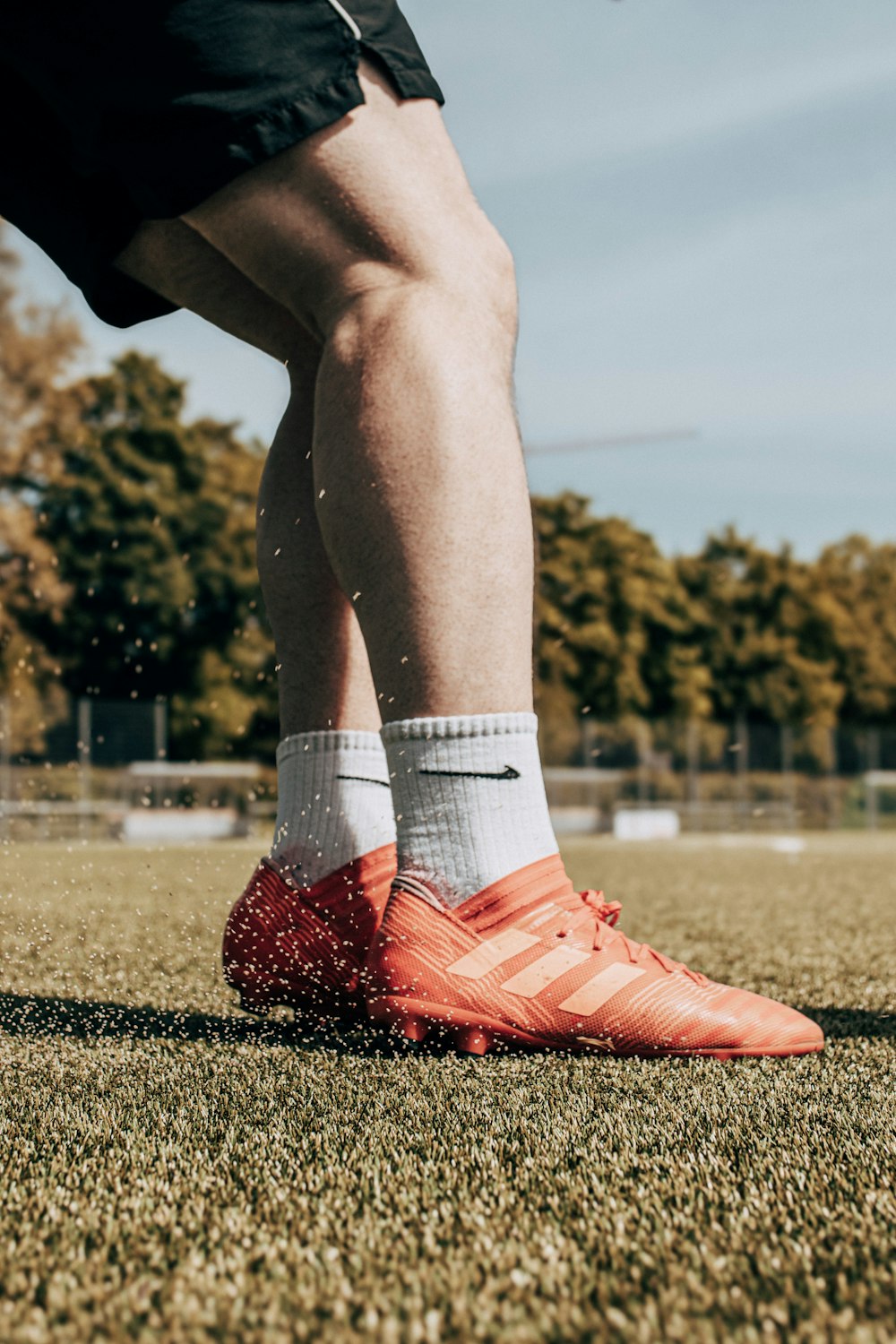 a soccer player is kicking a ball on the field