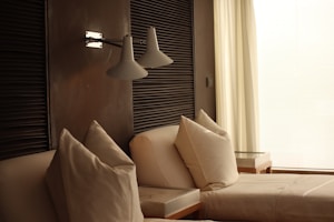 a bed room with a neatly made bed next to a window