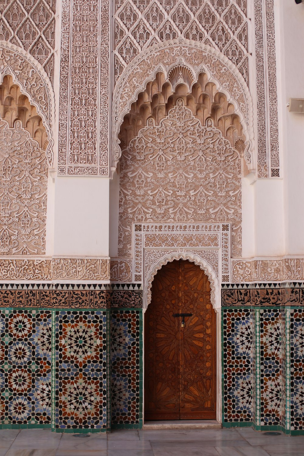 a wooden door in a building with a tiled wall