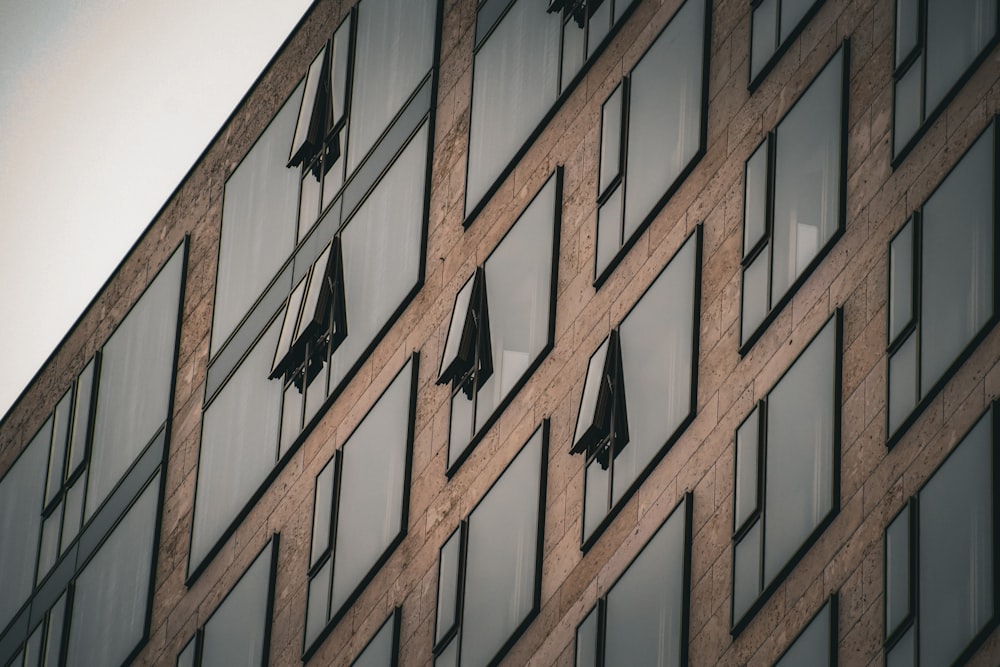 a building with many windows and umbrellas hanging from the windows