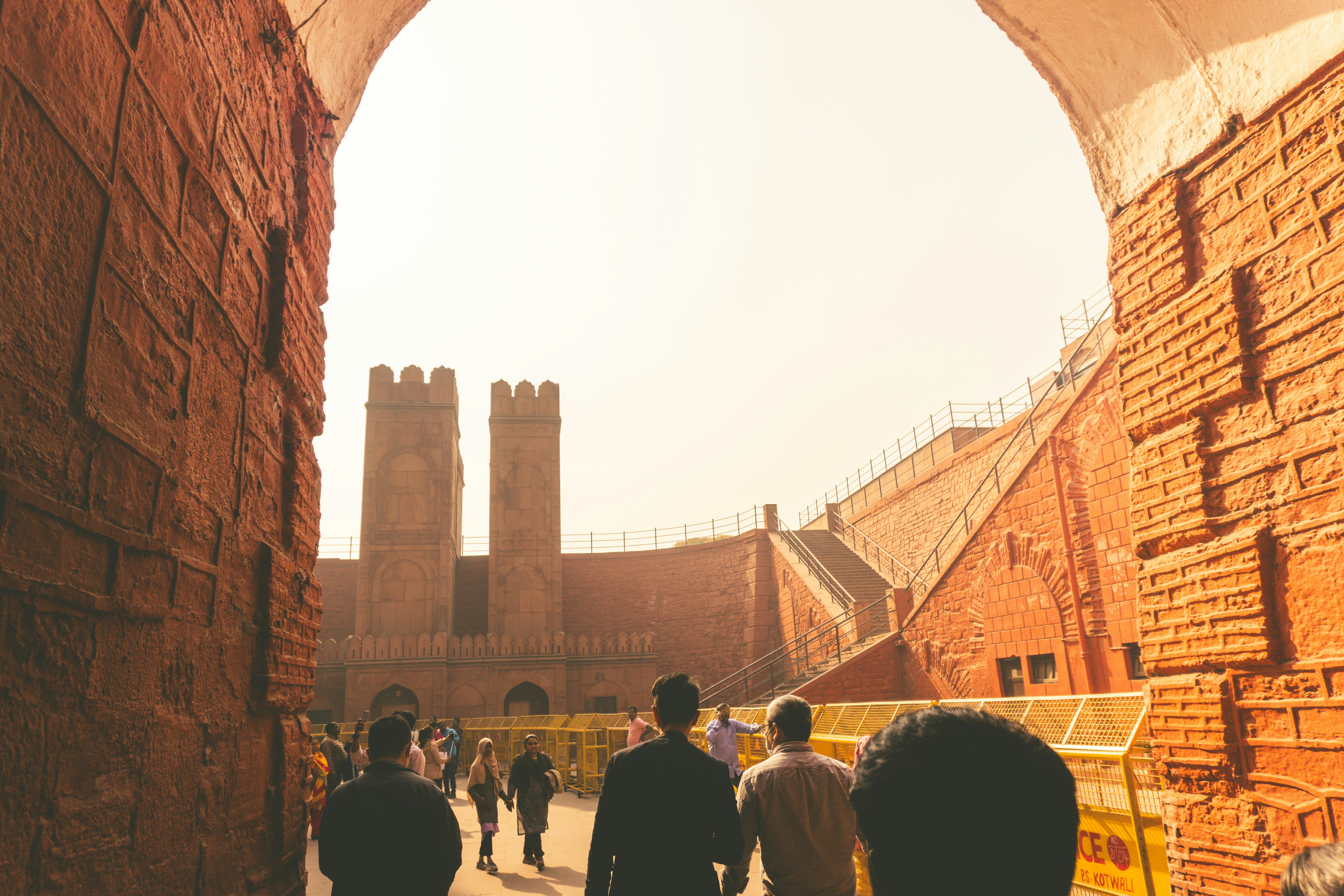 a group of people walking through a brick tunnel