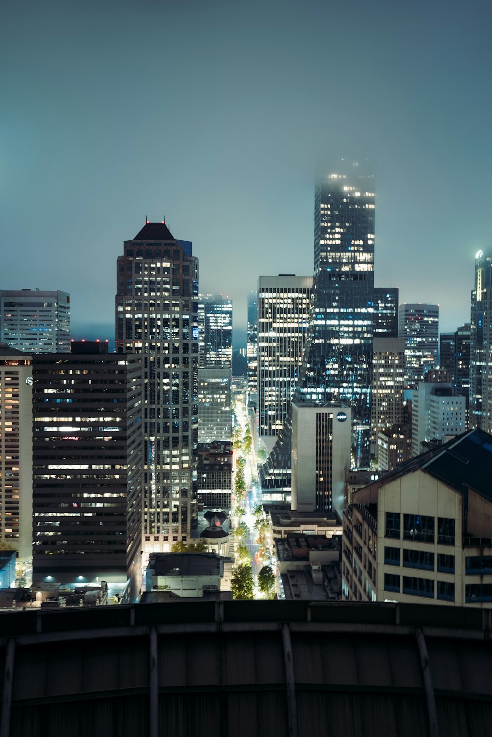 a view of a city at night from the top of a building