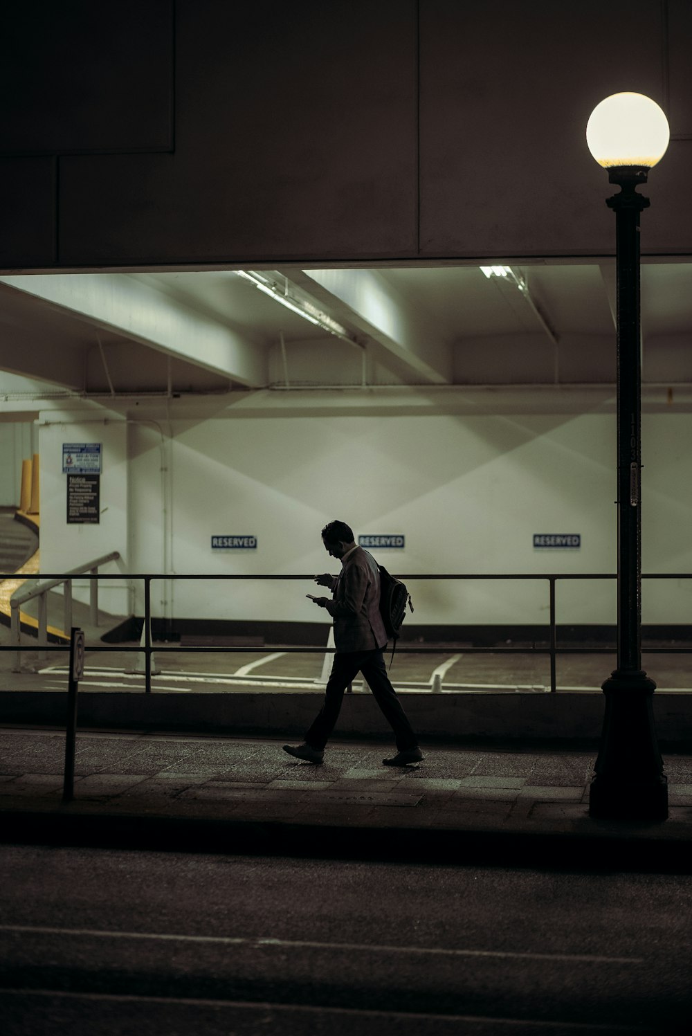 a man walking down a street at night